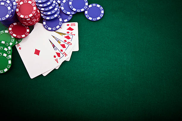 Royal flush and gambling chip on a green poker table