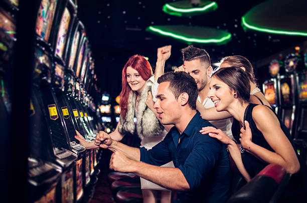 Group of people playing slot machines